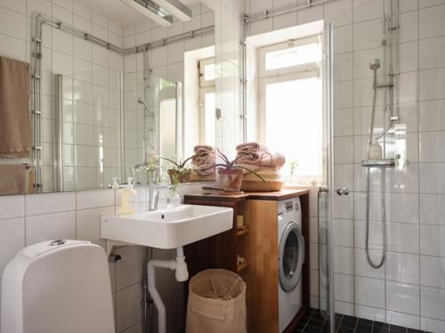 Скандинавская квартира с красивой серо-голубой кухней и розово - бежевыми оттенками в интерьере. 04