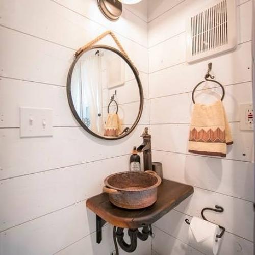 Небольшой двухэтажный домик с состаренными красными досками на фасаде в в городе уэйко, техас. 03