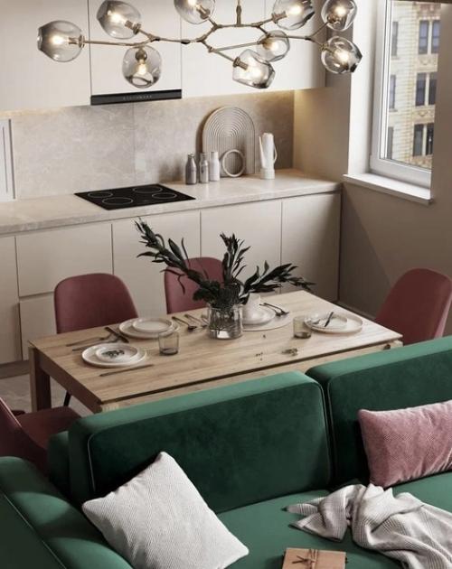 Красивая кухня - гостиная с акцентным зелёным диваном и обустроенной тв - зоной. 03
