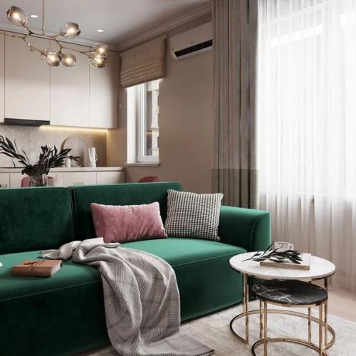 Красивая кухня - гостиная с акцентным зелёным диваном и обустроенной тв - зоной. 02