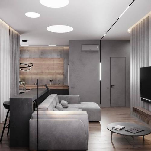 Для оформления интерьера этой кухни - гостиной было выбрано контрастное сочетание тёмного графита с текстурой бетона и дерева. 03