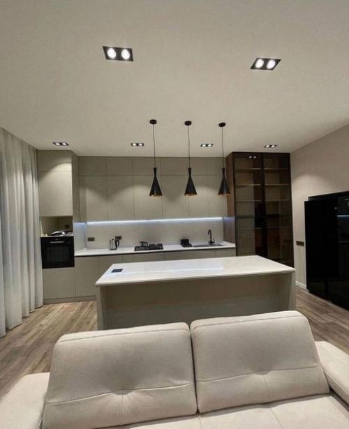 Кухню объединили с гостиной и установили небольшой остров, который упрощает жизнь хозяйке. 01