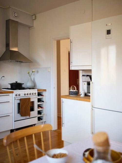 Небольшая квартира с приятными зелеными и деревянными акцентами. 01