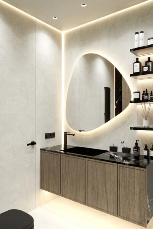 Зеркало с подсветкой имеет оригинальную форму, что делает его стильным и современным элементом интерьера. 01