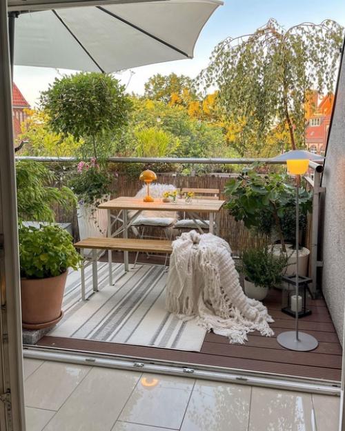 Светлый и стильный интерьер современной квартиры с деревянными элементами, теплым освещением и красивым текстилем и декором. 03