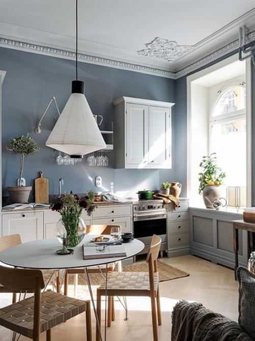 Лепной декор на потолке и необычные рамы окон в интерьере квартиры с серо-голубыми стенами и светильниками в скандинавском стиле. 02