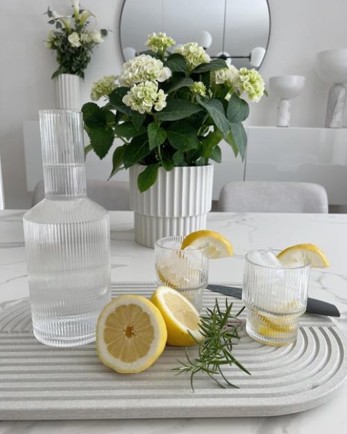 Элегантный белый интерьер с живыми цветами и теплым освещением. 04